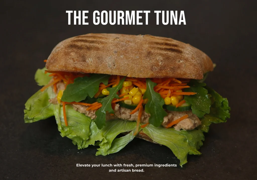 Creamy tuna sweetcorn sandwich on wholemeal bread with crisp lettuce and a side of vegetable crisps.