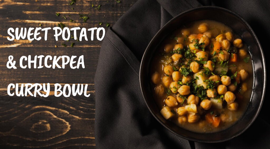 Vibrant vegan sweet potato and chickpea curry bowl with fresh spinach, red peppers, and a creamy coconut milk base.