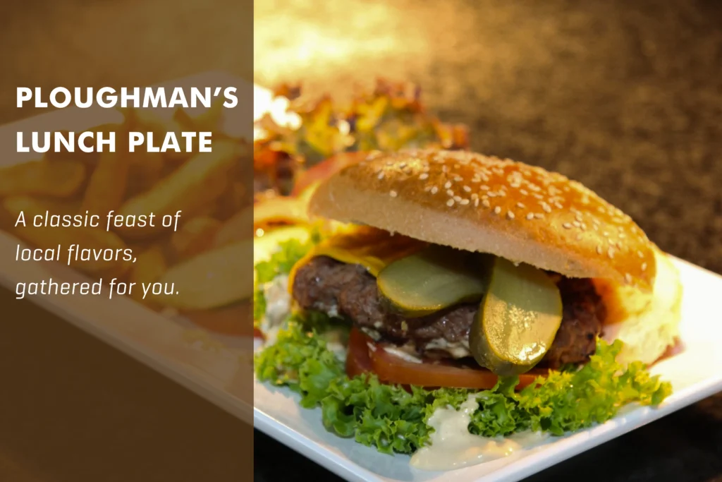 Traditional London Ploughman’s lunch with mature cheddar, thick-cut ham, crusty bread, and a side of Branston pickles.