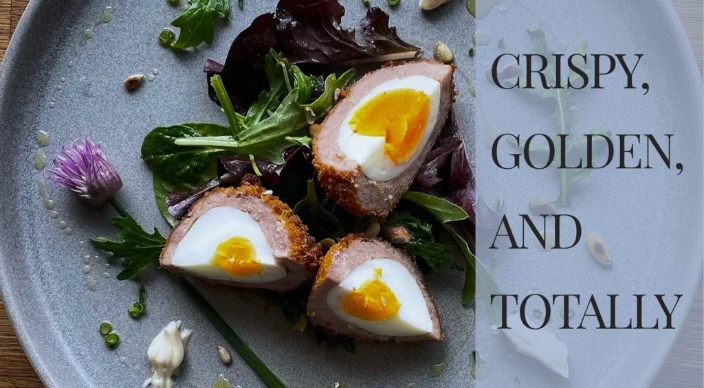 A soft-boiled Scotch egg sliced in half showing a jammy golden yolk, crispy sausage meat coating, and panko breadcrumbs.