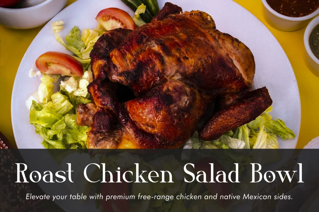 Healthy roast chicken salad bowl with sliced avocado, cherry tomatoes, cucumber, and a lemon herb dressing.