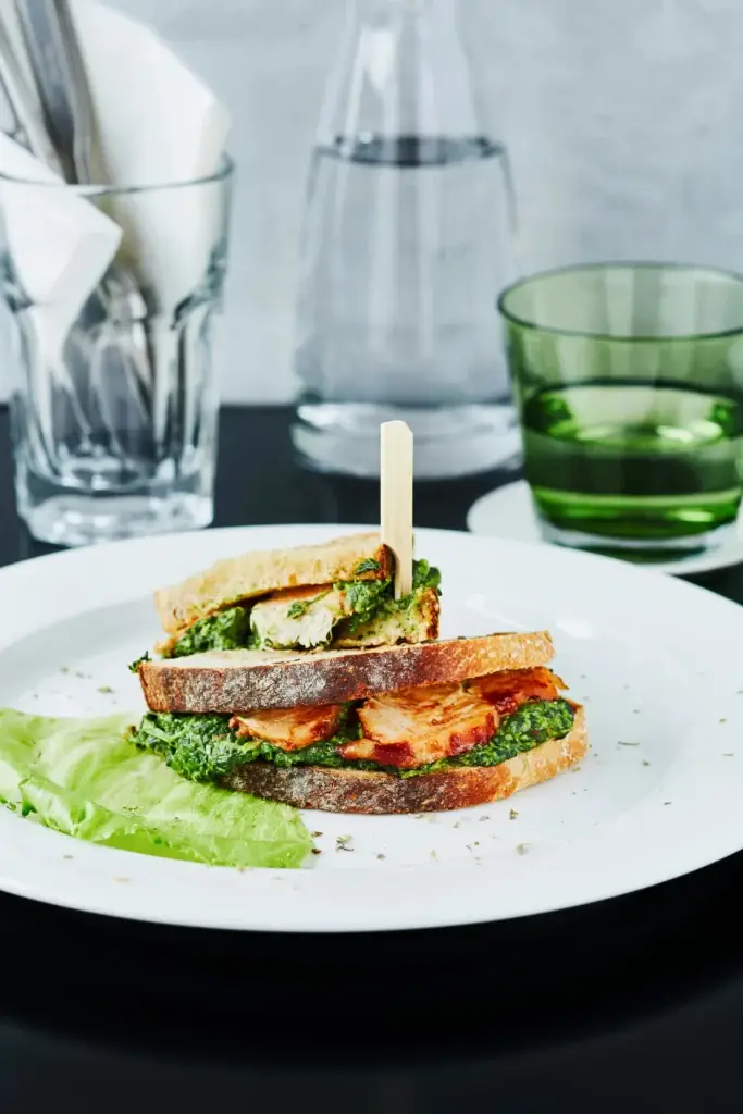 Grilled halloumi breakfast sandwich with fried egg and spinach.