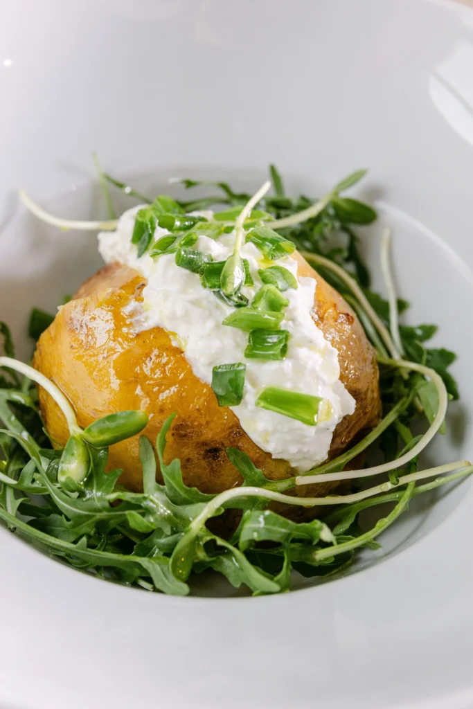 Crispy baked potato filled with hot beans and grated cheese.