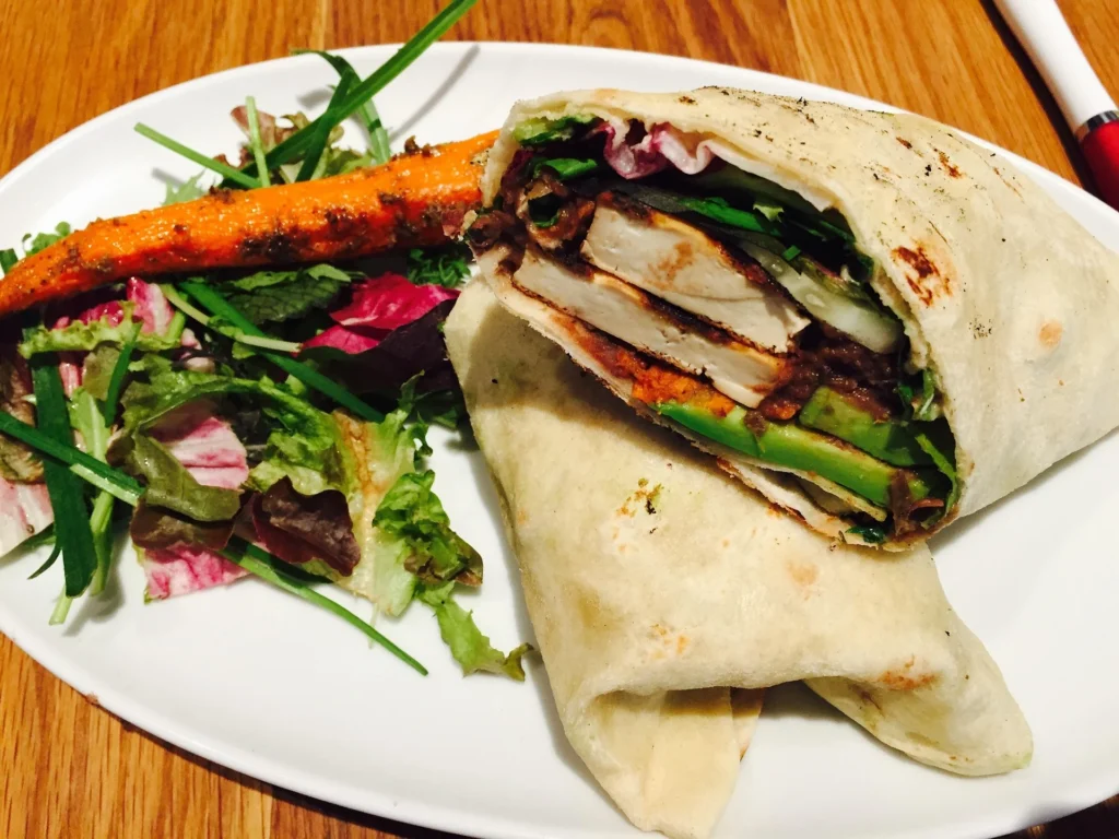Chicken and avocado wrap with fresh lettuce and creamy dressing.