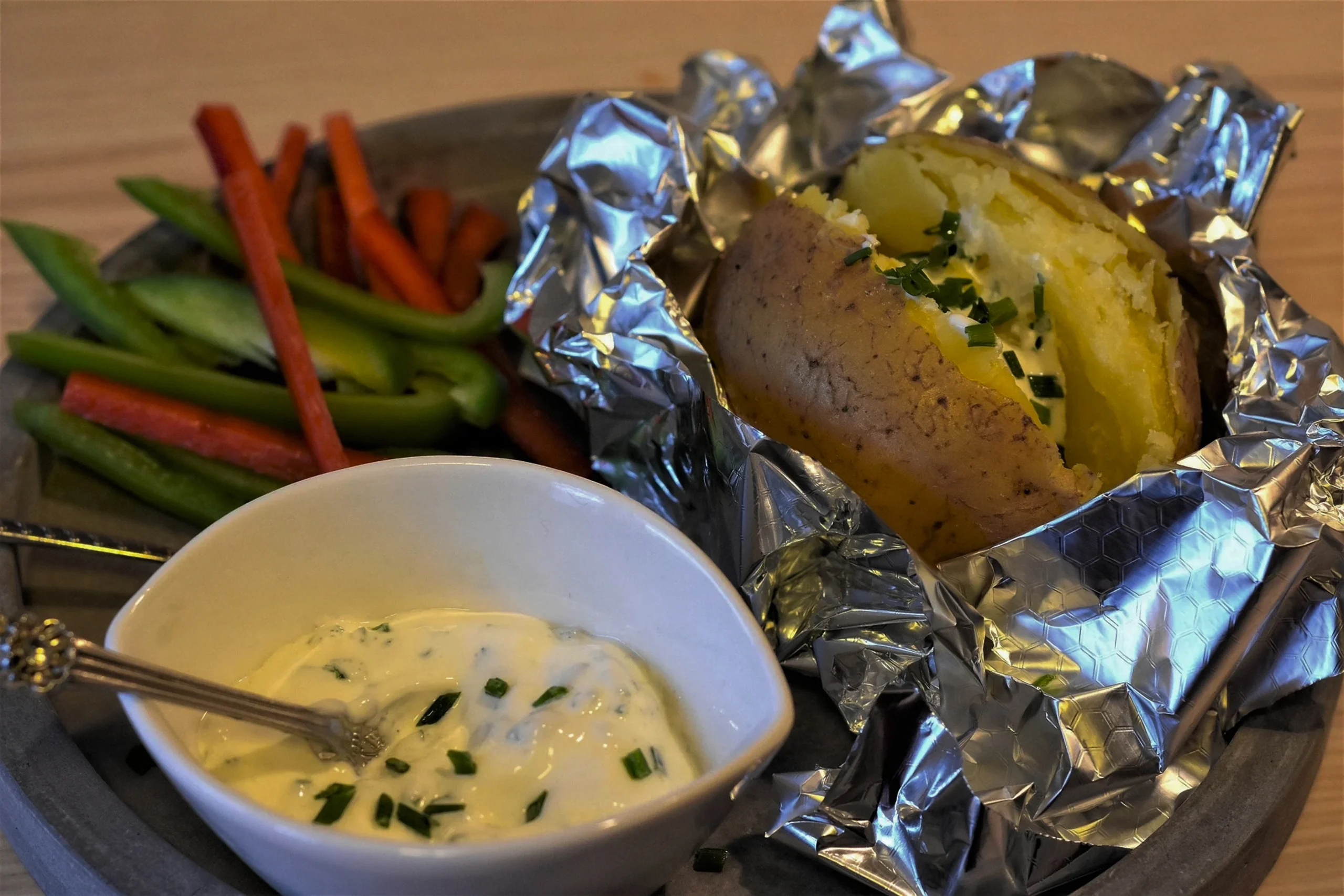 Perfectly baked jacket potato with Heinz-style beans and grated cheddar, a classic British lunch recipe.