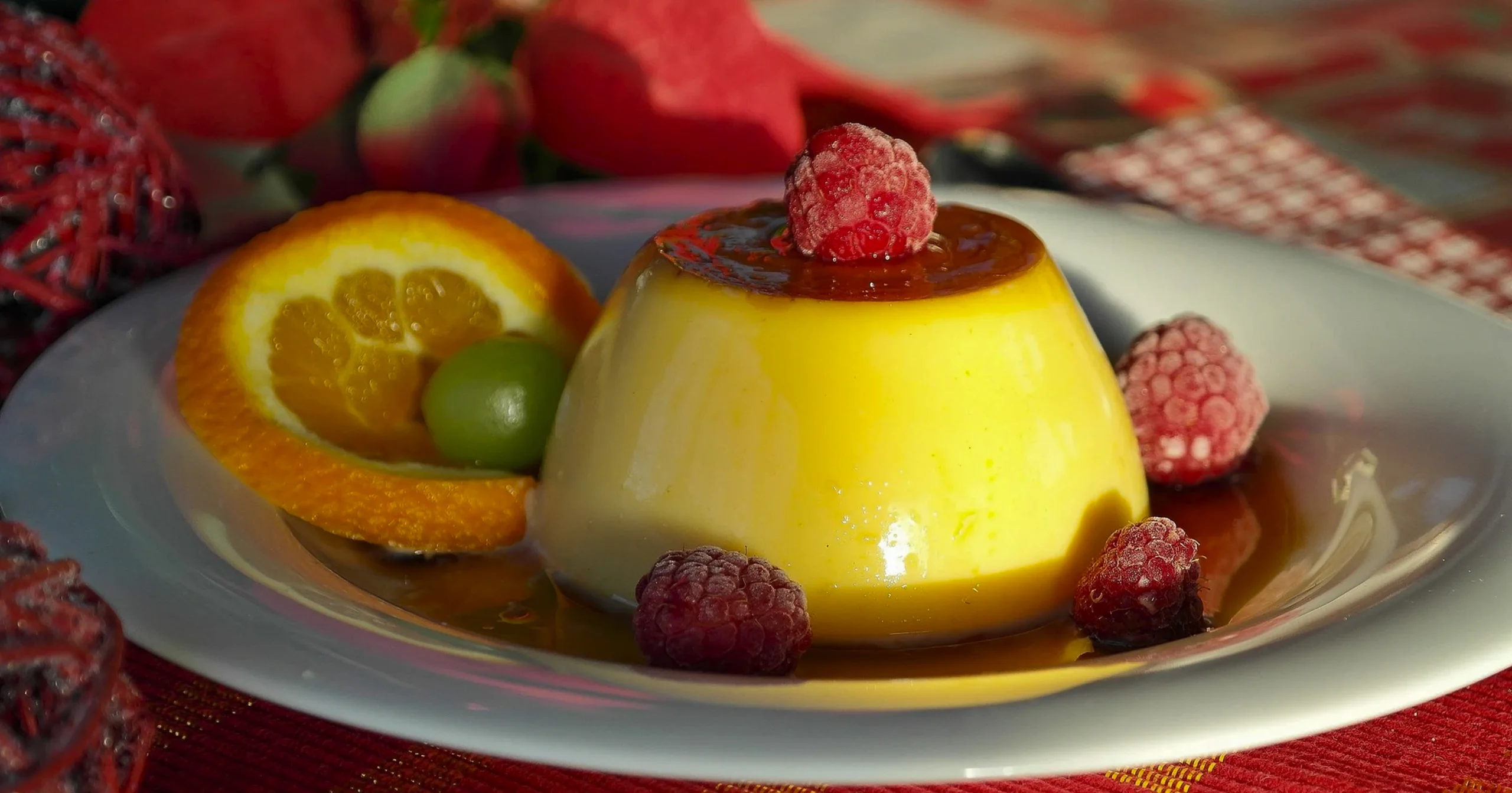Close-up of a moist date sponge cake soaked in rich caramel sauce, showing the airy texture and dark golden color.