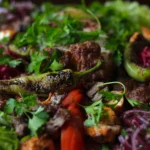 Tender pieces of lamb in an authentic Rogan Josh sauce served in a bowl, a gluten-free dinner idea.