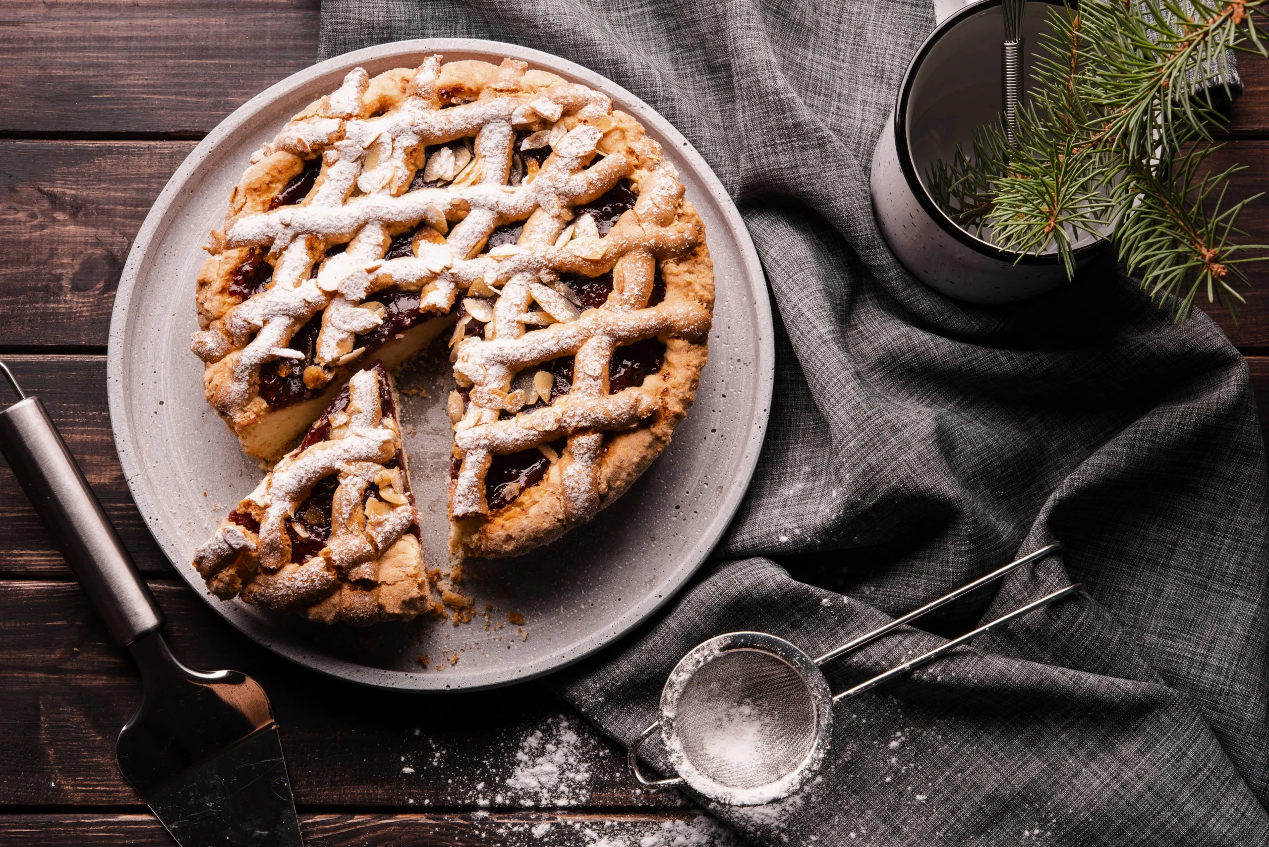 Classic English Banoffee Pie topped with shaved dark chocolate and a drizzle of caramel on a white dessert plate.