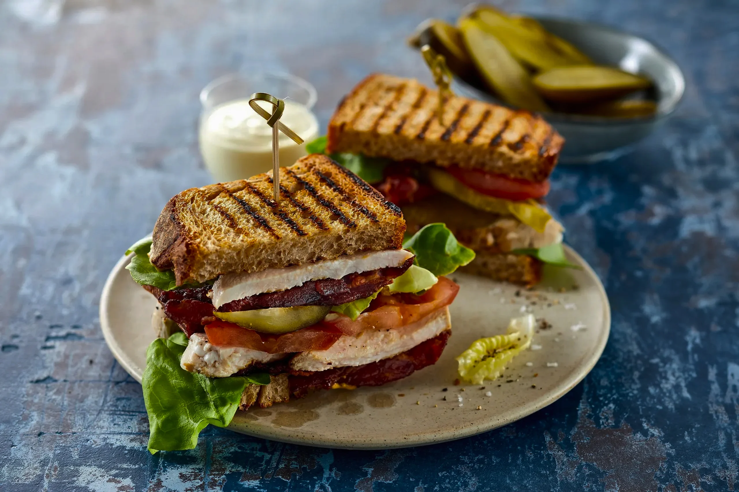 Close-up of golden-brown pan-fried halloumi with a runny yolk egg and fresh spinach in a breakfast roll.