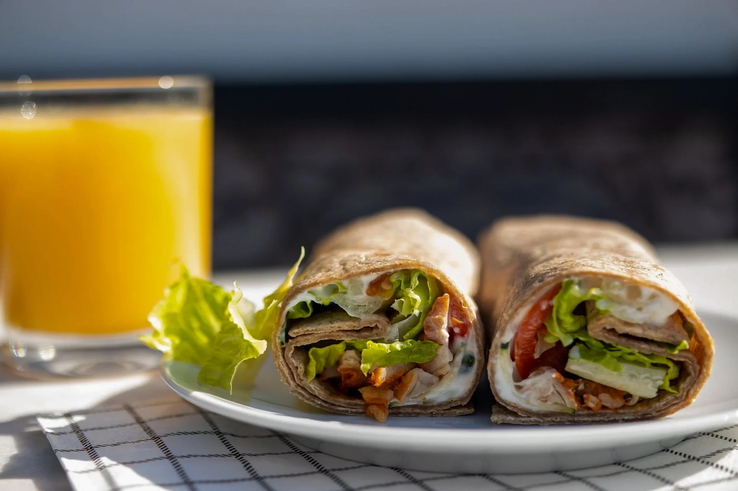 Close-up of a protein-packed breakfast wrap with Cumberland sausage, avocado, and a spicy tomato salsa.