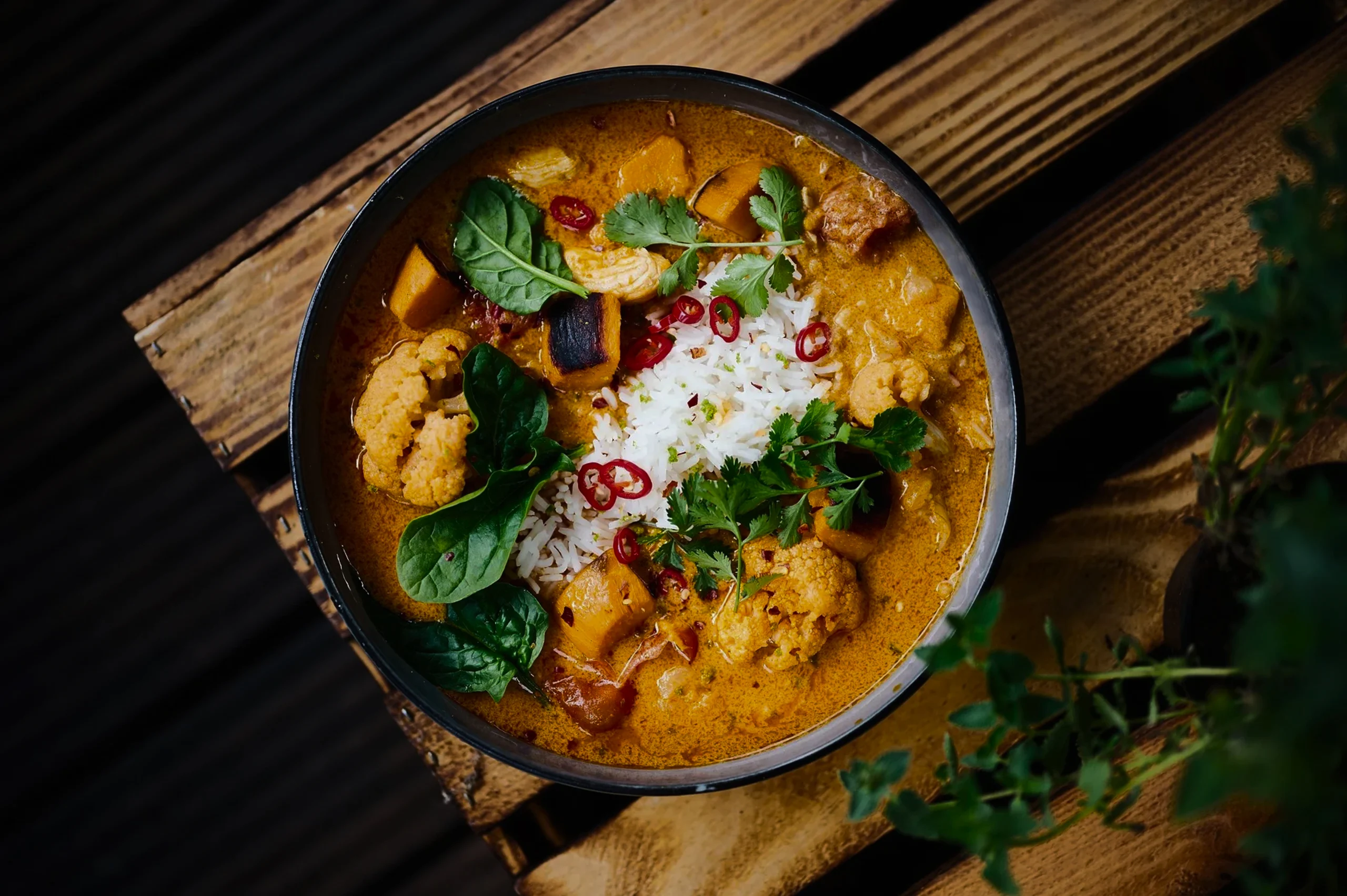 Homemade Chicken Katsu Curry recipe with a thick, aromatic brown sauce and a side of pickled ginger and salad.