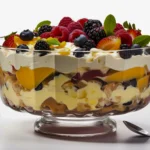 Side view of a colorful English trifle showing distinct layers of berries, cream, and custard for a festive dessert.