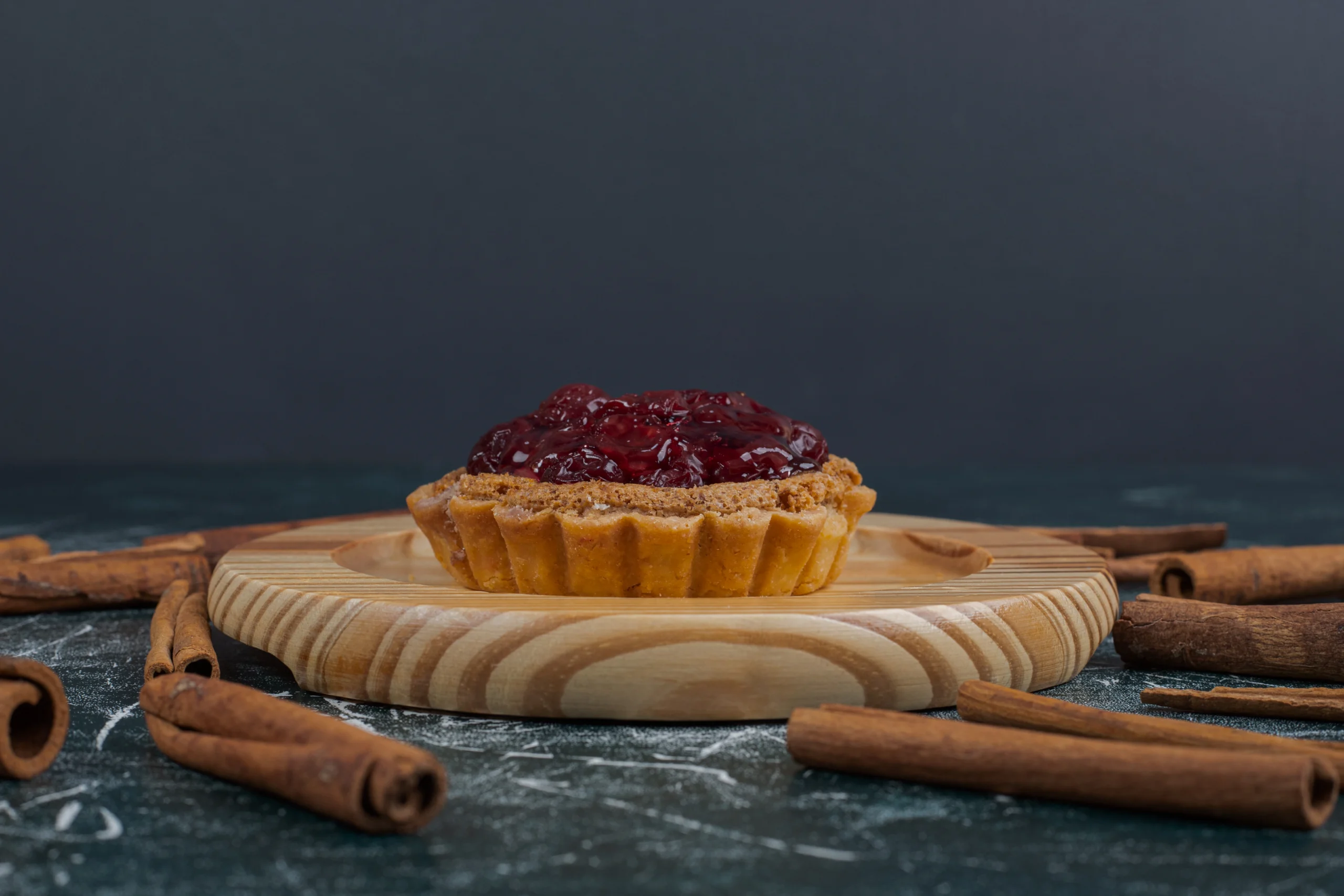 Slice of treacle tart showing the thick, sticky breadcrumb and golden syrup filling inside a buttery shortcrust pastry.
