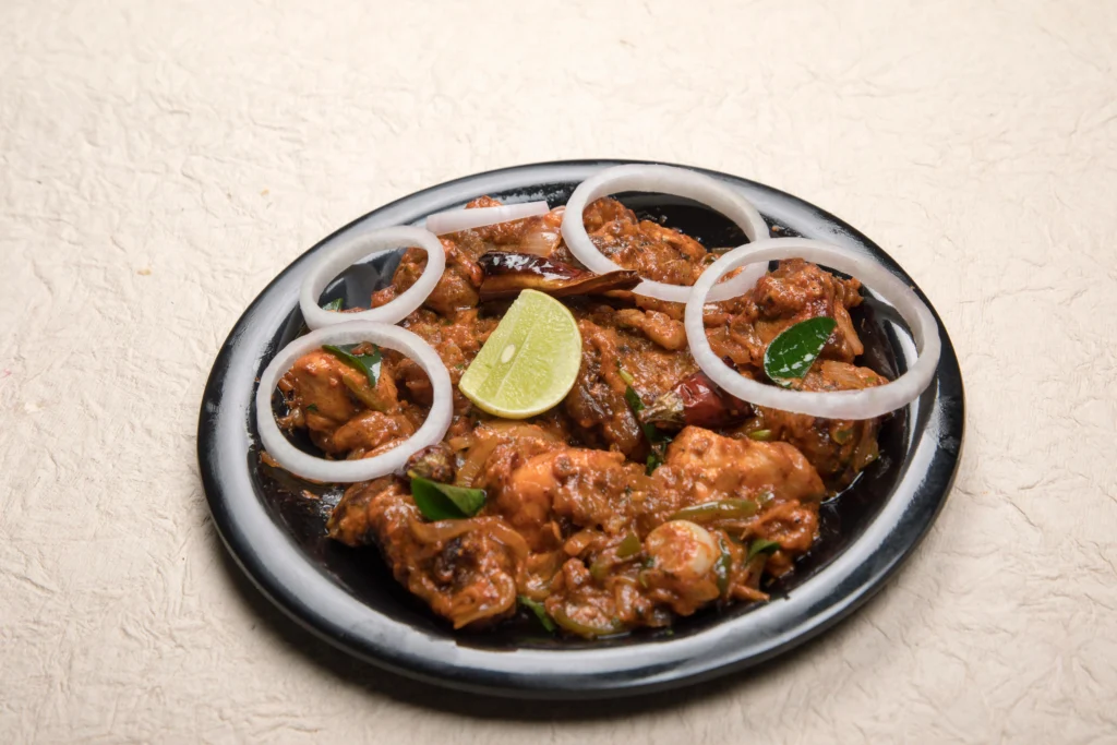 Classic Chicken Tikka Masala featuring grilled tandoori chicken chunks in a rich, creamy tomato and onion sauce, served with fragrant basmati rice and fresh cilantro