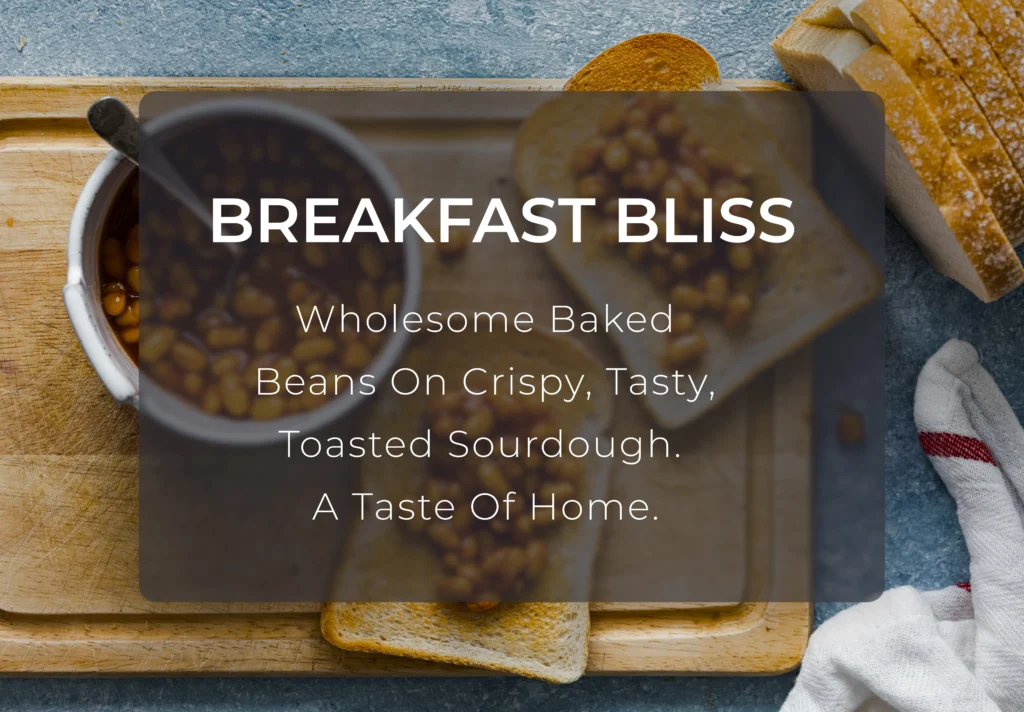 A golden-brown slice of thick sourdough toast topped with a generous portion of warm baked beans in tomato sauce, served on a ceramic plate.