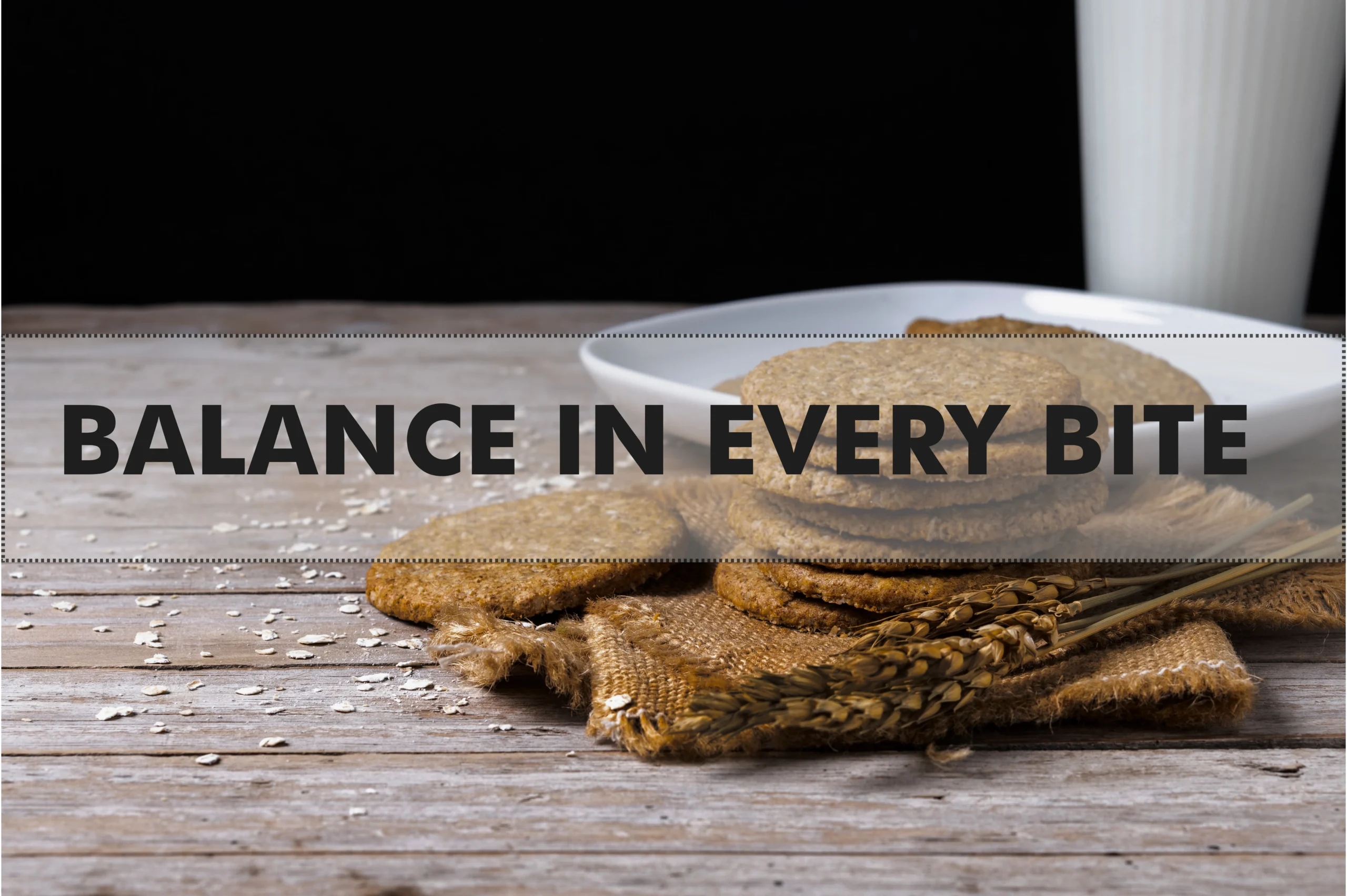 Wholewheat digestive biscuits stacked neatly on a wooden board next to a cup of tea.