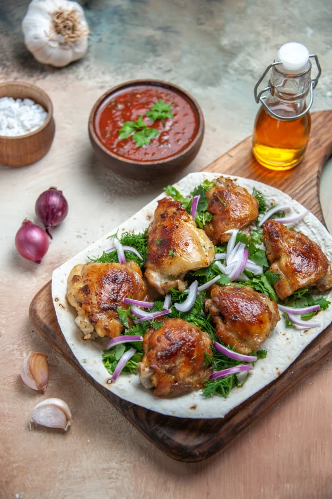 Spicy garlic chicken thighs seared golden-brown in a skille