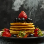 Golden-brown American pancakes cooking on a flat griddle, showing the perfect bubbles forming on the surface