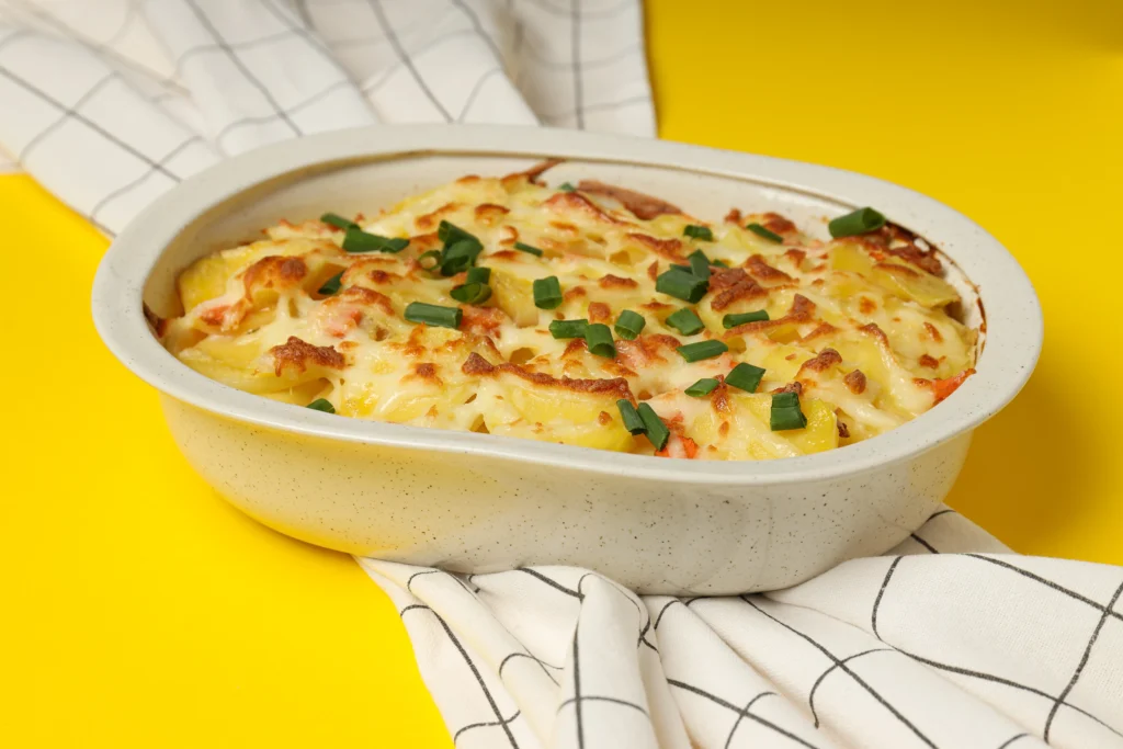Hearty chicken pie and mash served on a classic white plate with steamed vegetables and a sprig of fresh thyme