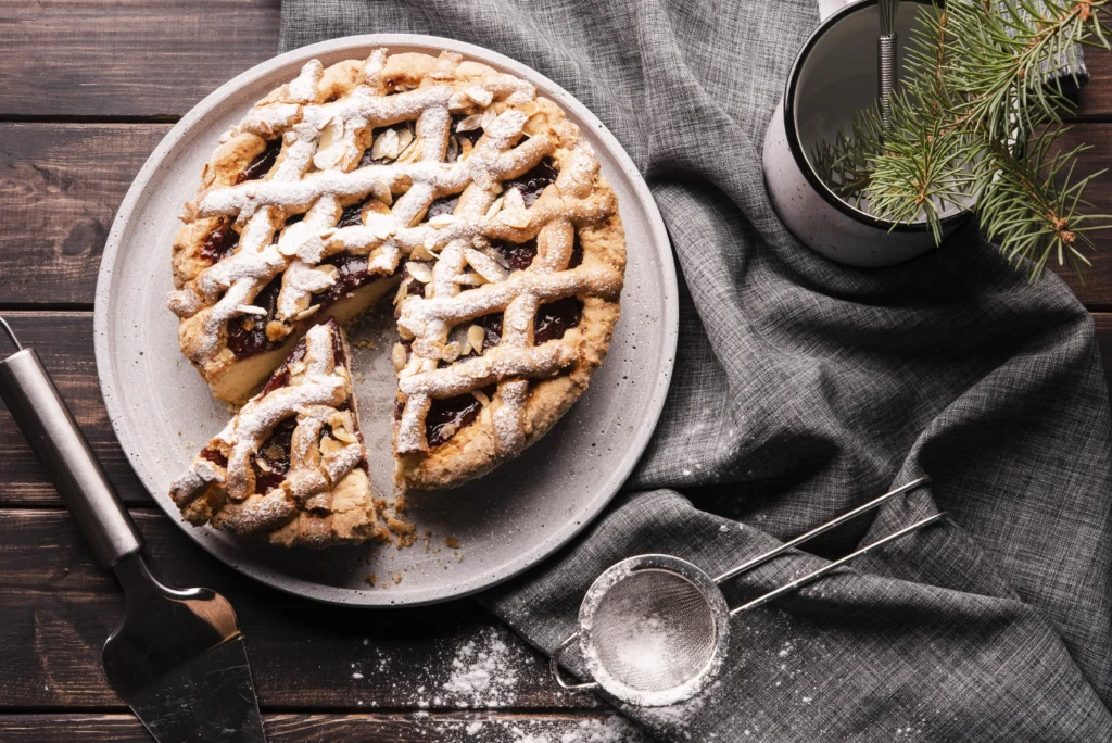 Gourmet Banoffee pie garnished with shaved chocolate and coffee powder on a marble cake stand