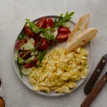 Close-up of velvety scrambled eggs with small curds, demonstrating the perfect low-and-slow cooking technique