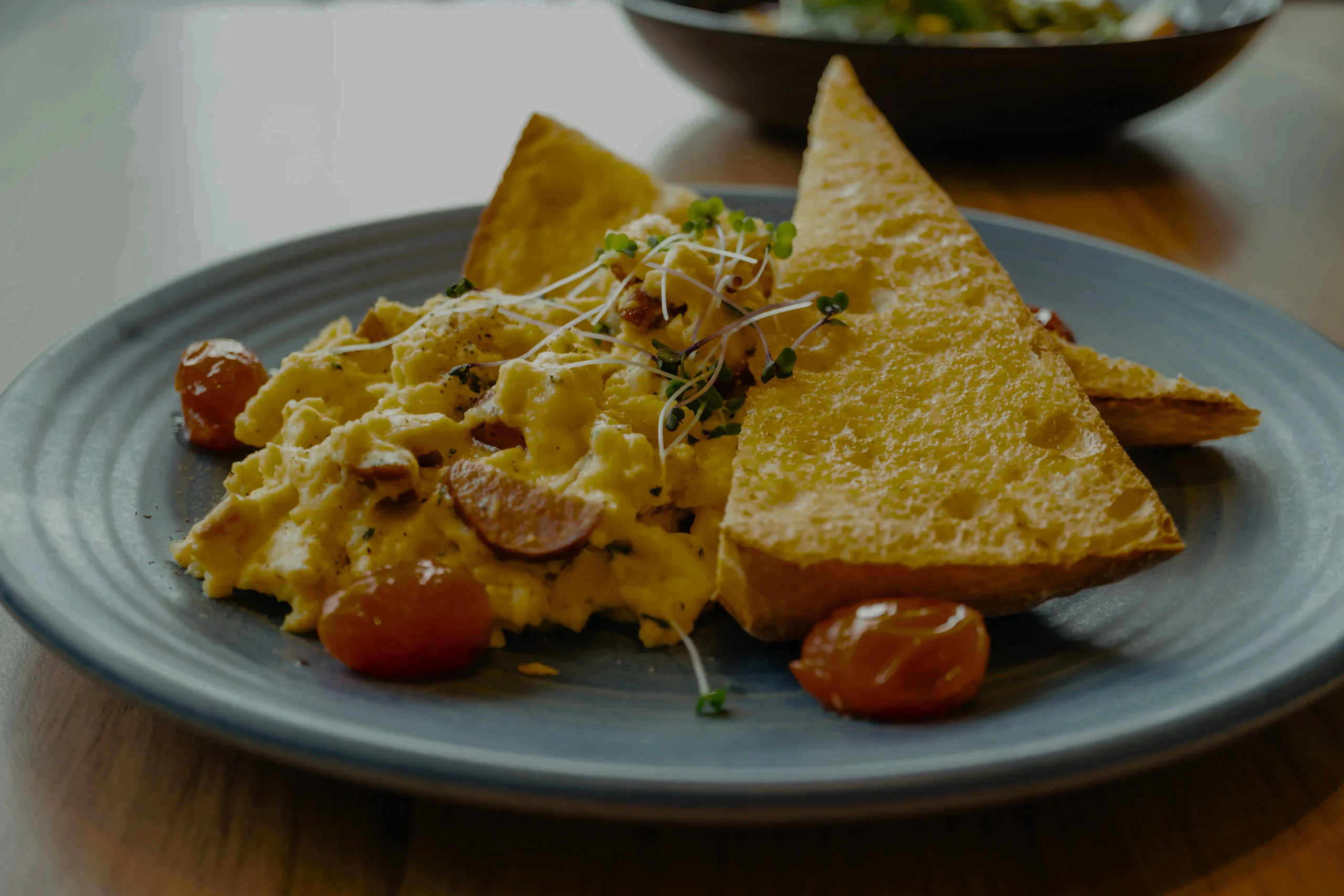 Silky, buttery folded eggs on a slice of golden toasted brioche, a gourmet breakfast-in-bed inspiration.