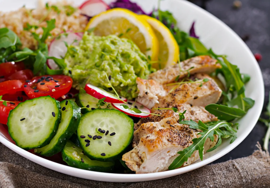 Close-up detail of juicy grilled chicken breast with deep grill marks and a fresh lemon drizzle, showcasing the texture and succulent finish of the protein.