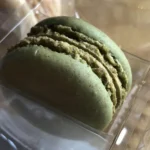 Step-by-step process of making pistachio macarons including piping batter, resting shells, and baking French macarons at home