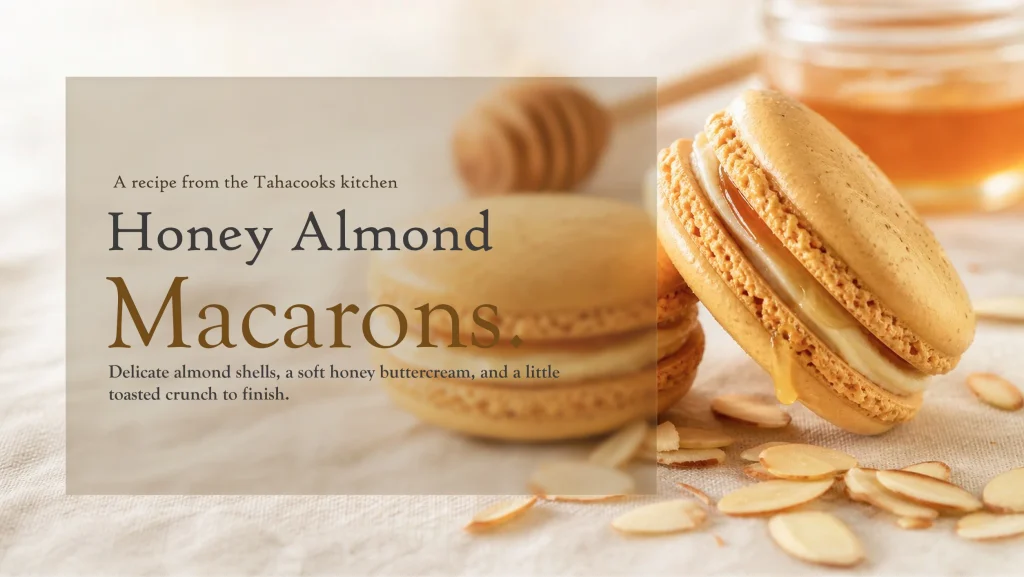 Honey almond macarons stacked on a plate with a jar of honey in the background