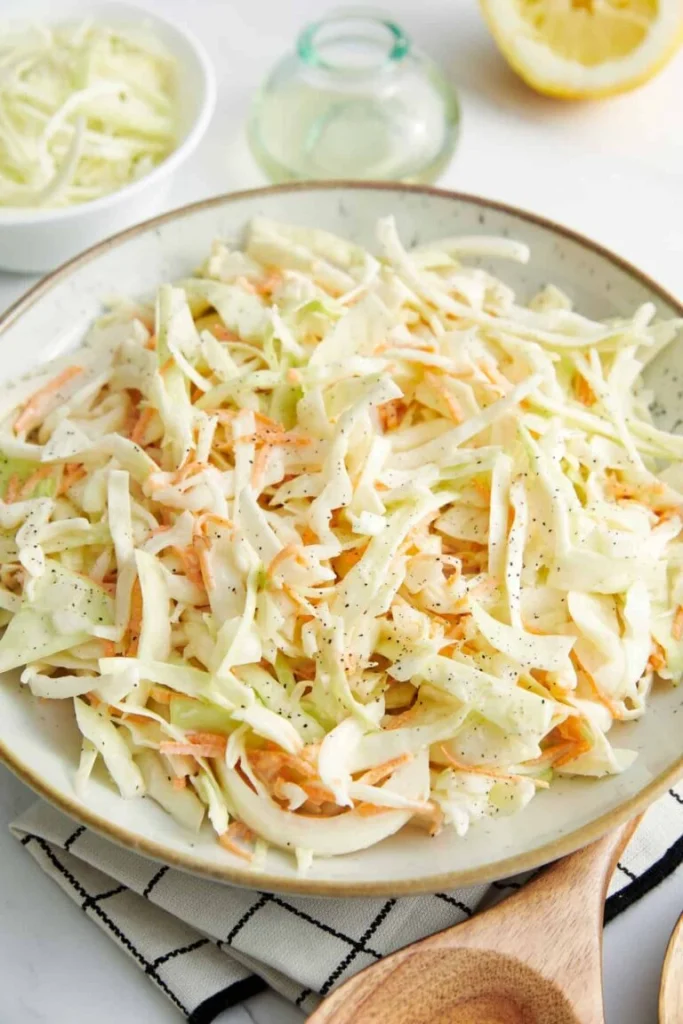 Homemade classic coleslaw with creamy dressing served as a barbecue side dish.
